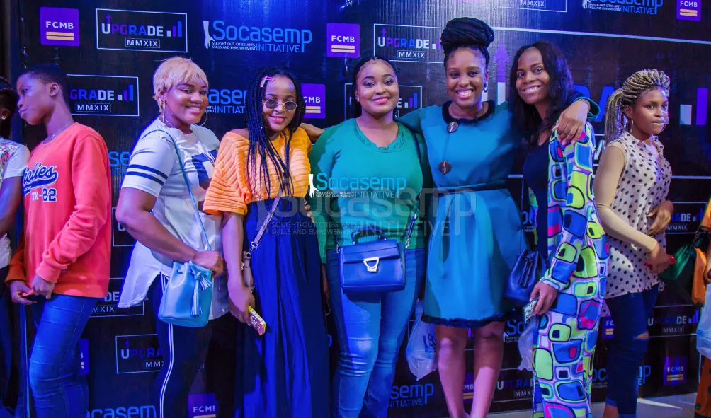 UPGRADE 2019 participants smiling together in front of the SOCASEMP backdrop